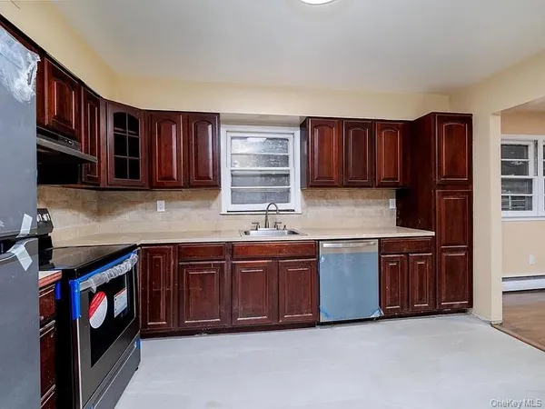 a kitchen with stainless steel appliances granite countertop wooden cabinets a sink and dishwasher