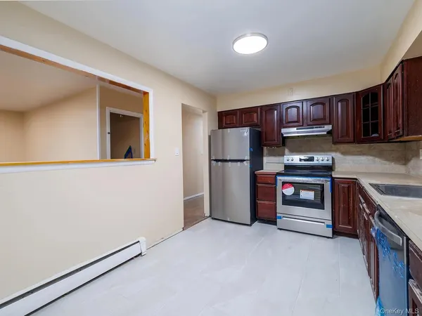 a kitchen with stainless steel appliances a refrigerator and a stove top oven