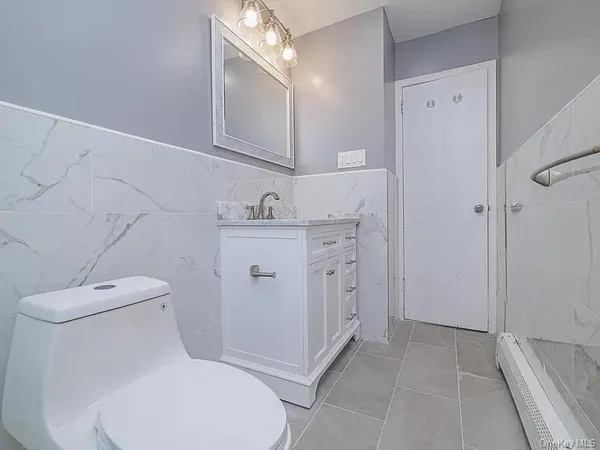 a white toilet sitting next to a bathroom sink