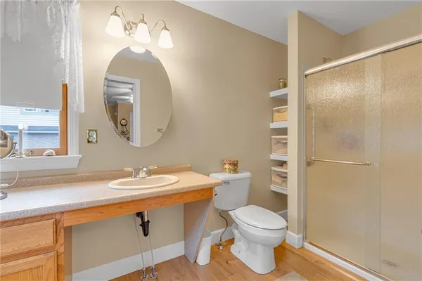 a bathroom with a toilet a sink and a mirror