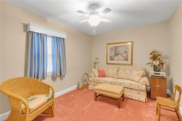 a bedroom with a bed couch and a window