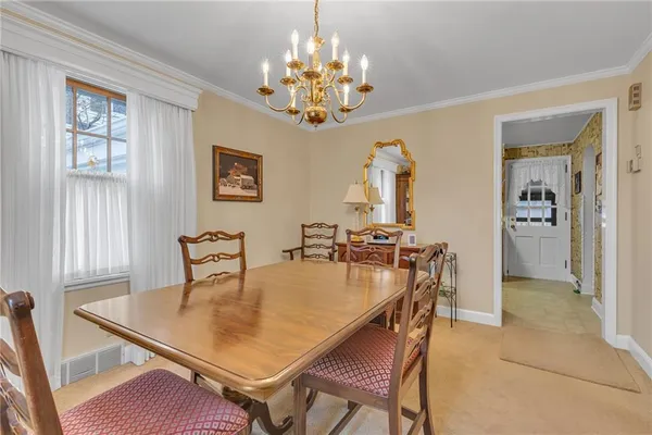 a dining room with furniture and chandelier