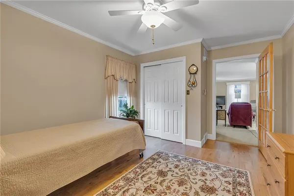 a spacious bedroom with a bed and a dresser