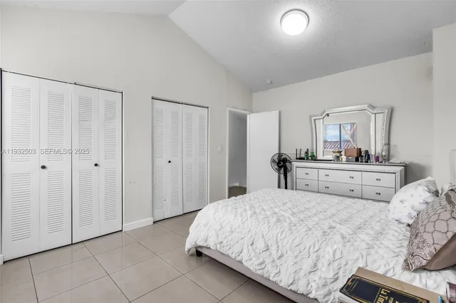 a bedroom with a bed and a lamp