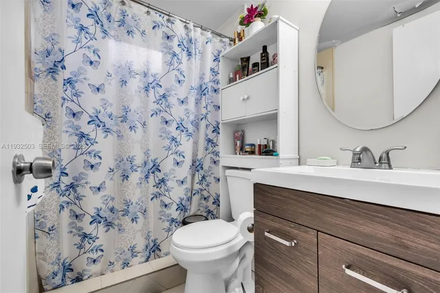 a bathroom with a sink toilet and mirror