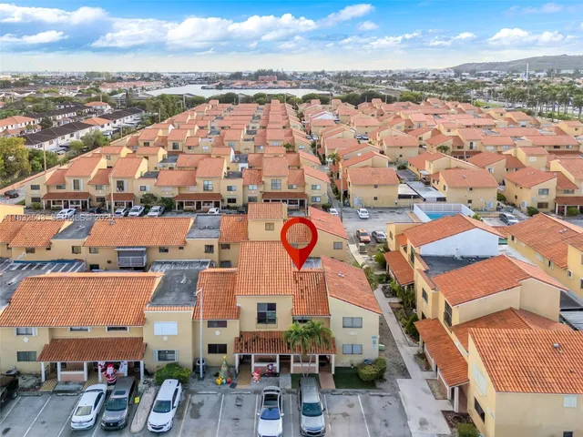 an aerial view of residential building and lake