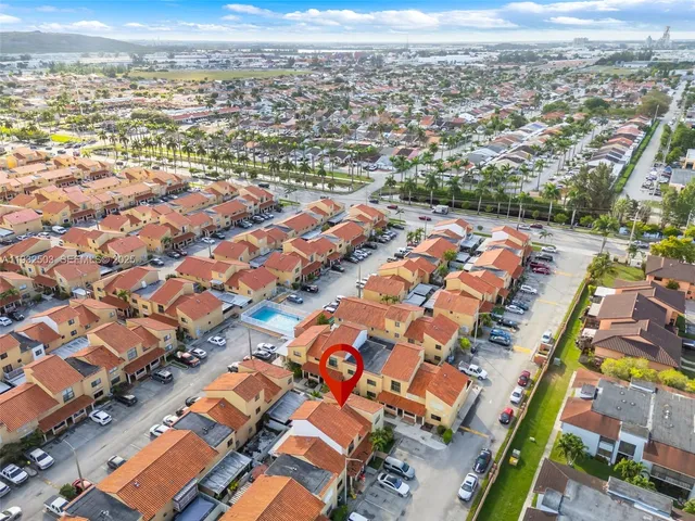 an aerial view of residential houses with outdoor space