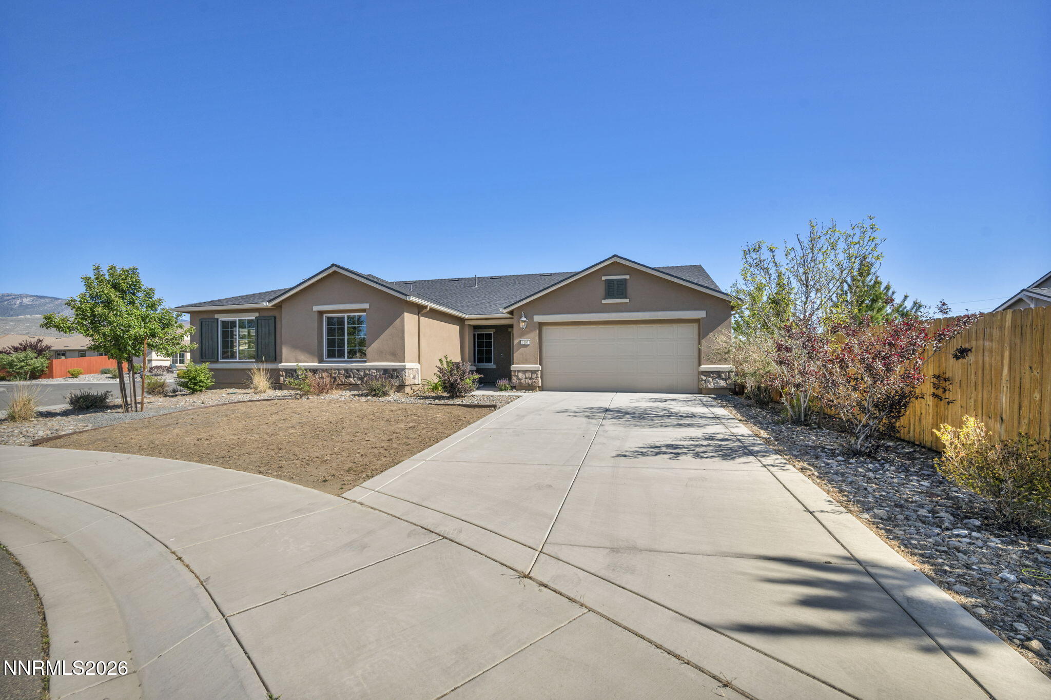7181 Saddlehorn Road Carson City, NV 89701 - Photo 2 of 62 a front view of a house with a yard and garage