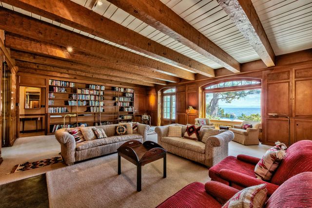 a living room with furniture a couch and large windows