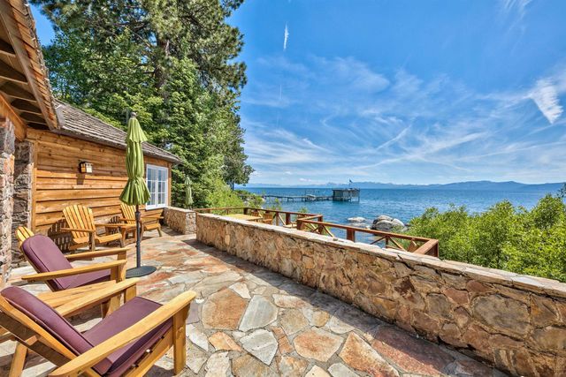a view of balcony with two chairs and a table