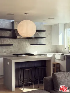 a kitchen with a sink a stove and cabinets