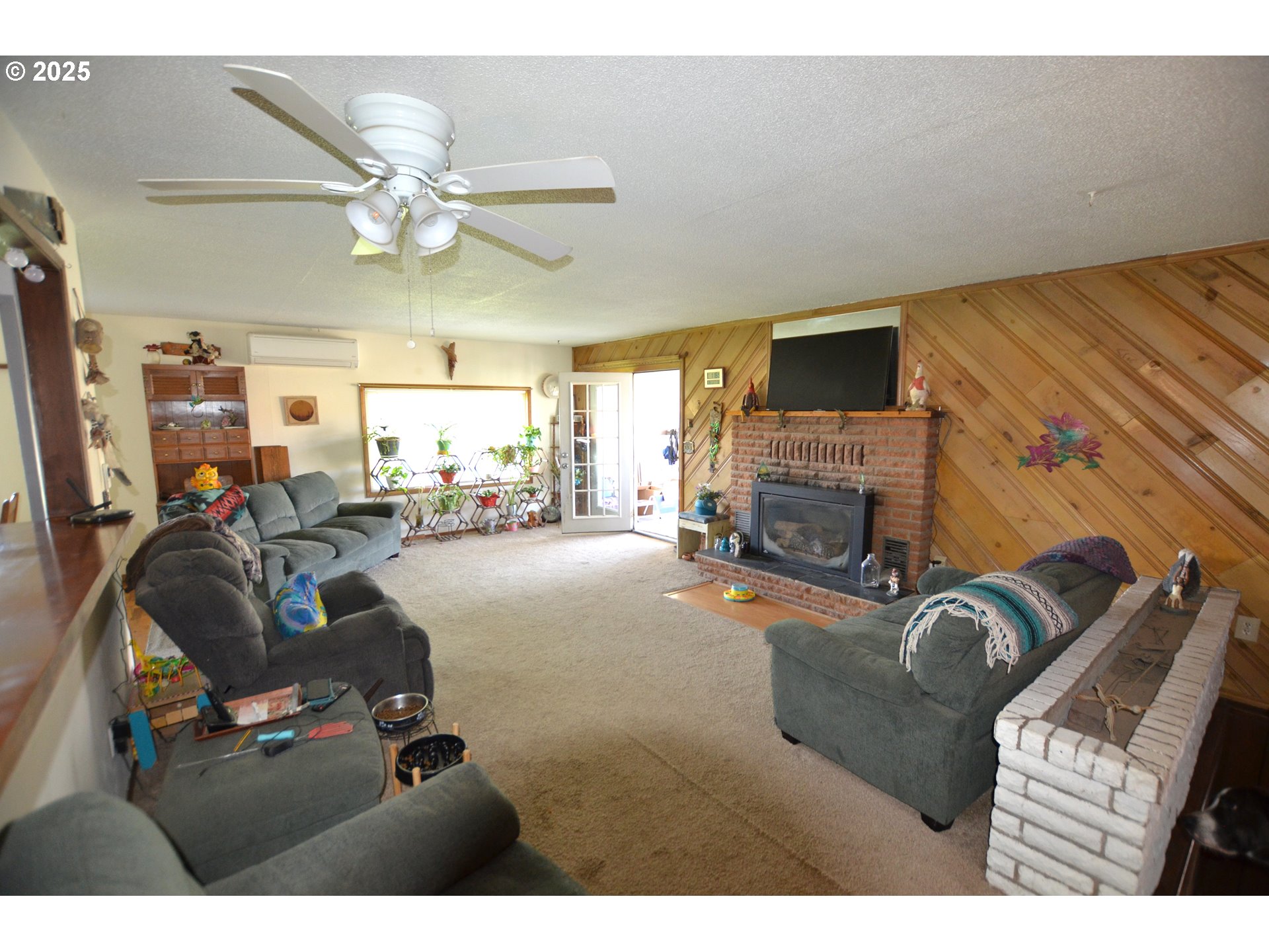46083 Adams Road Pendleton, OR 97801 - Photo 28 of 47 a living room with furniture a fireplace and a flat screen tv