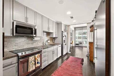 a kitchen with a sink stove and microwave
