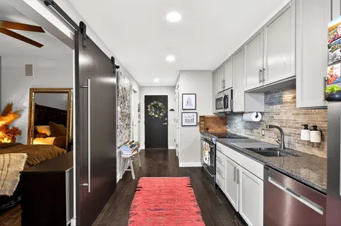 a kitchen with stainless steel appliances granite countertop a sink and cabinets