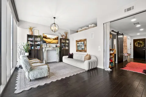 a living room with furniture and a chandelier