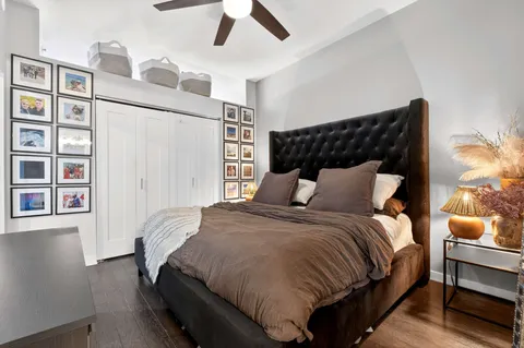 a bedroom with bed and wooden floor