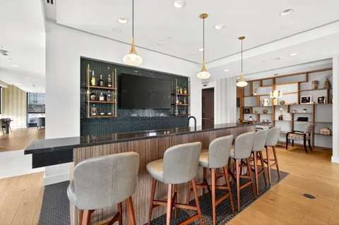 a workspace with furniture and floor to ceiling window