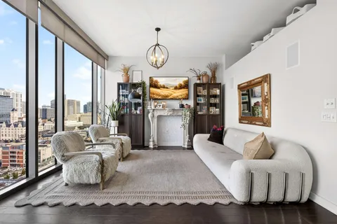 a living room with fireplace furniture and a large window