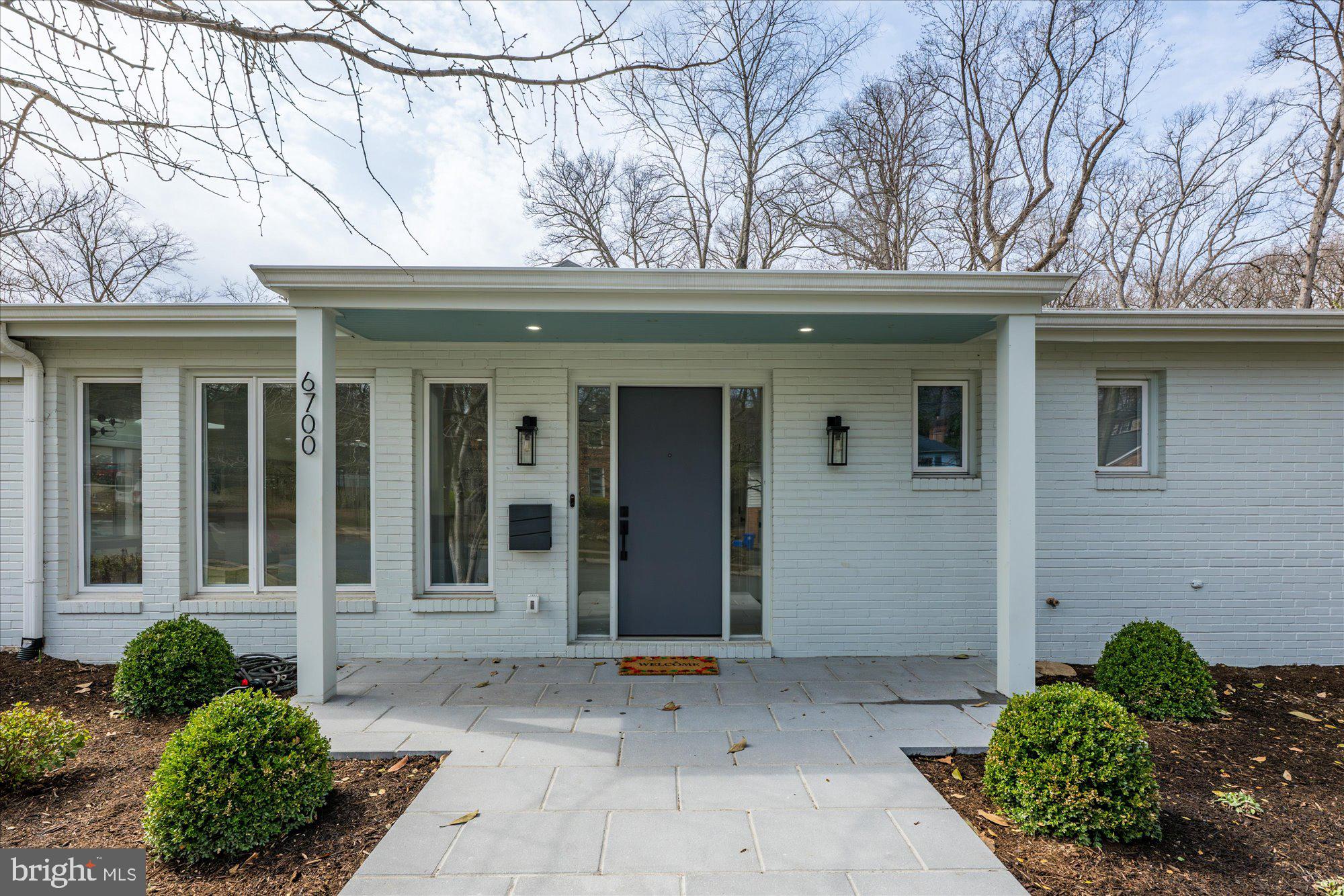 6700 Rannoch Road Bethesda, MD 20817 - Photo 2 of 36 a view of a house with a yard and potted plants