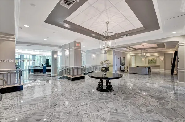 a lobby with furniture and stairs