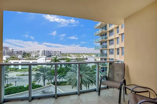 a view of a chairs and table in a balcony