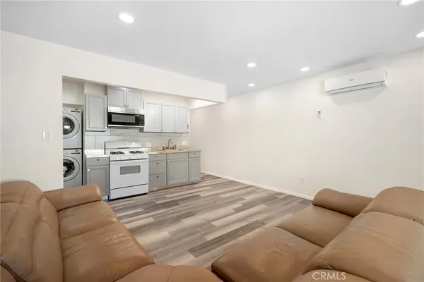 a kitchen with white cabinets and white appliances