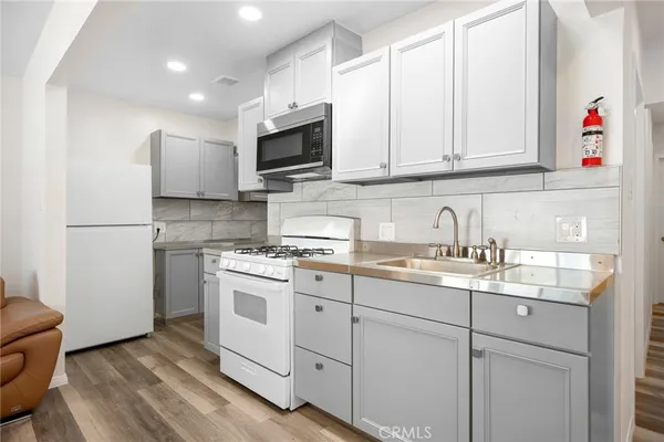a utility room with sink dryer and washer