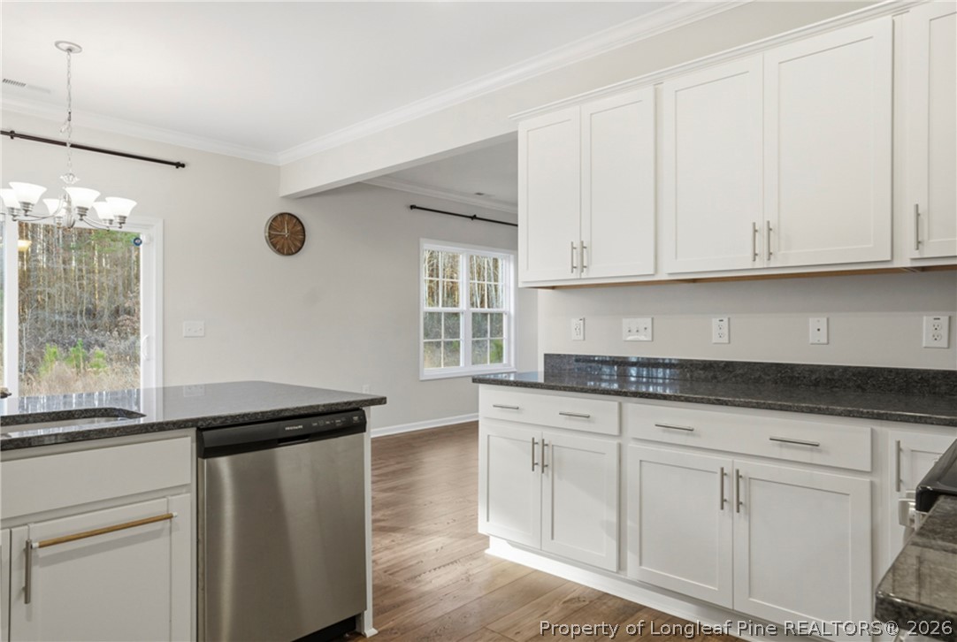 106 Knotts Berry Road Bunnlevel, NC 28323 - Photo 20 of 50 a kitchen with granite countertop white cabinets and a sink