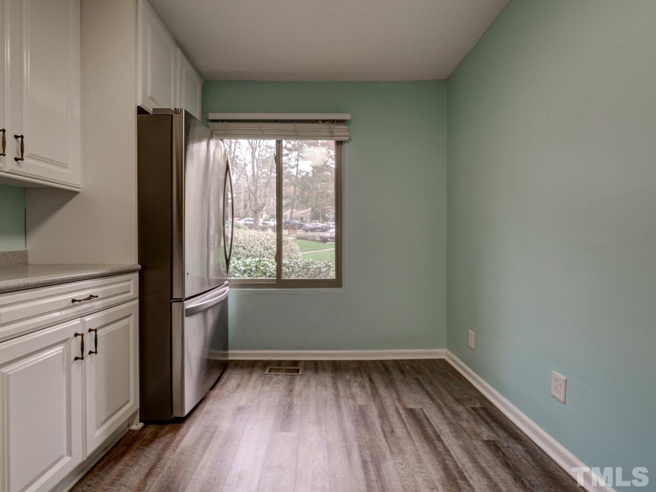 5857 Branchwood Road Raleigh, NC 27609 - Photo 17 of 42 a view of a kitchen with wooden floor and a window