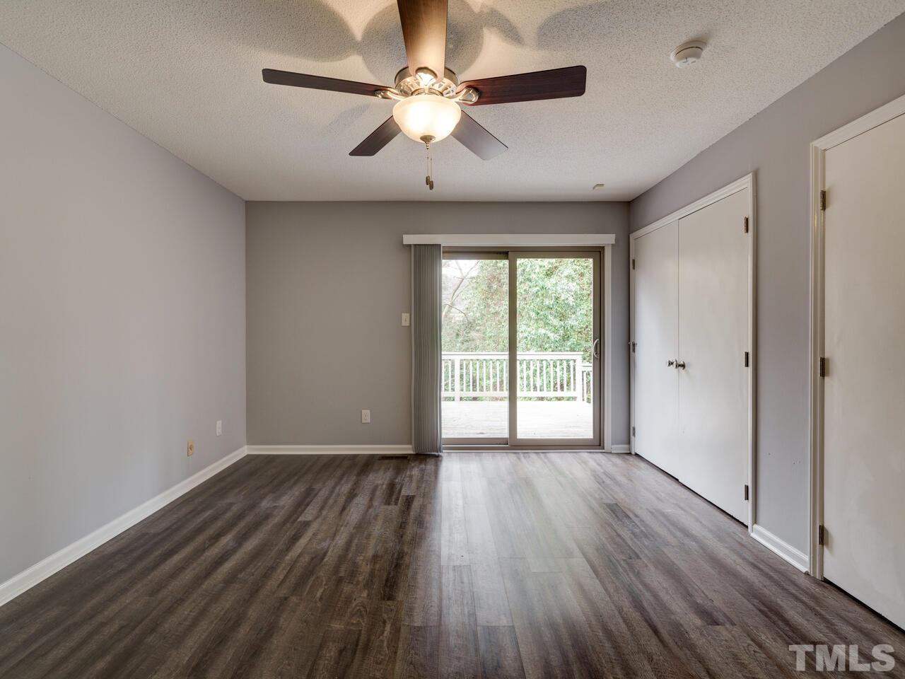 5857 Branchwood Road Raleigh, NC 27609 - Photo 19 of 42 wooden floor in an empty room with a window