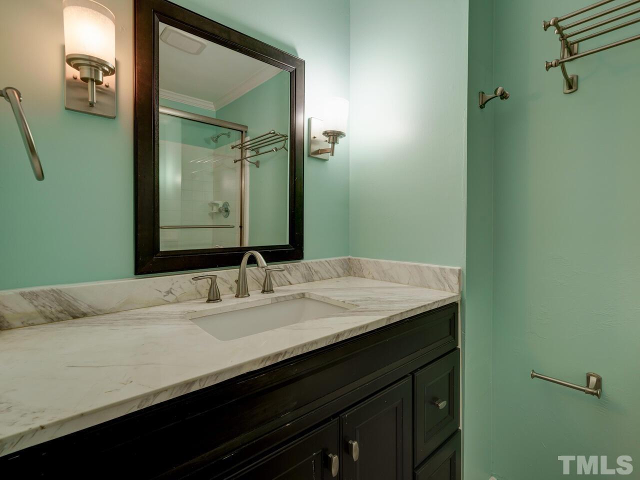 5857 Branchwood Road Raleigh, NC 27609 - Photo 22 of 42 a bathroom with a granite countertop sink and a mirror