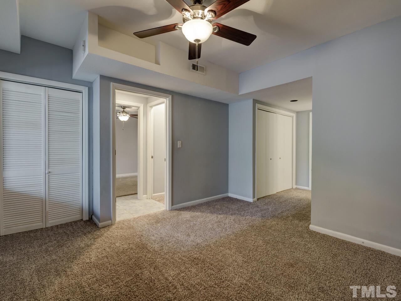 5857 Branchwood Road Raleigh, NC 27609 - Photo 30 of 42 a view of an empty room with a ceiling fan
