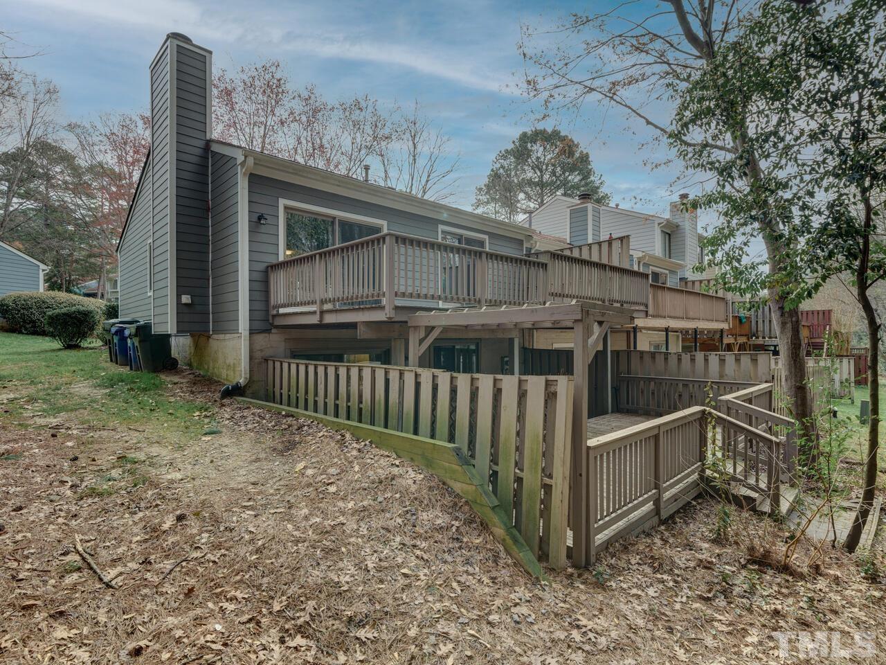 5857 Branchwood Road Raleigh, NC 27609 - Photo 5 of 42 a view of a house with a small yard and wooden fence