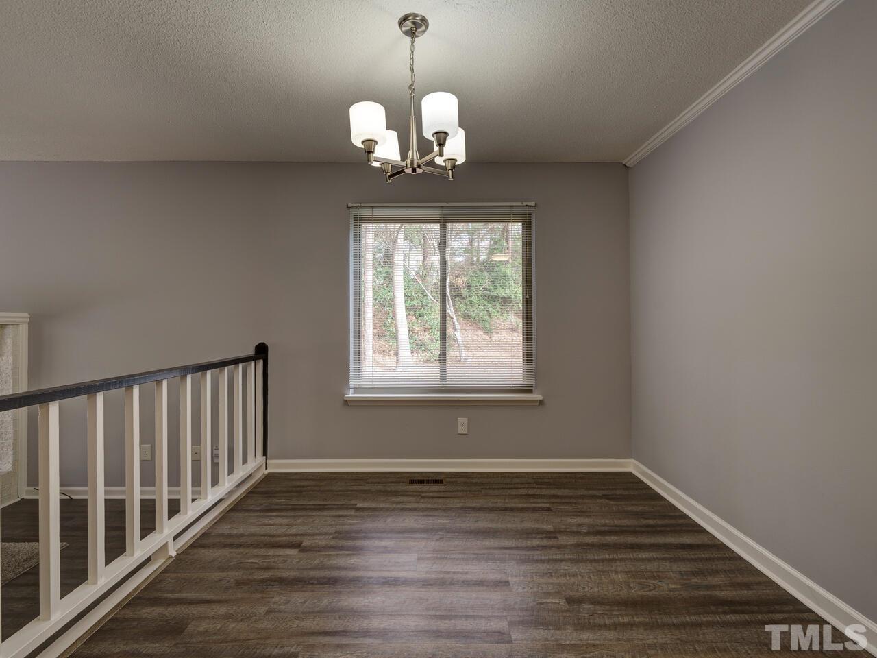 5857 Branchwood Road Raleigh, NC 27609 - Photo 8 of 42 a view of wooden floor and chandelier in room