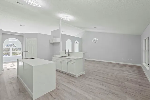 a spacious bathroom with a sink a mirror and a vanity