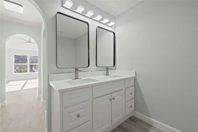 a bathroom with a double vanity sink and a mirror