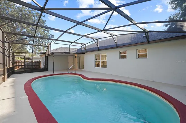 a view of a swimming pool with a lounge chairs