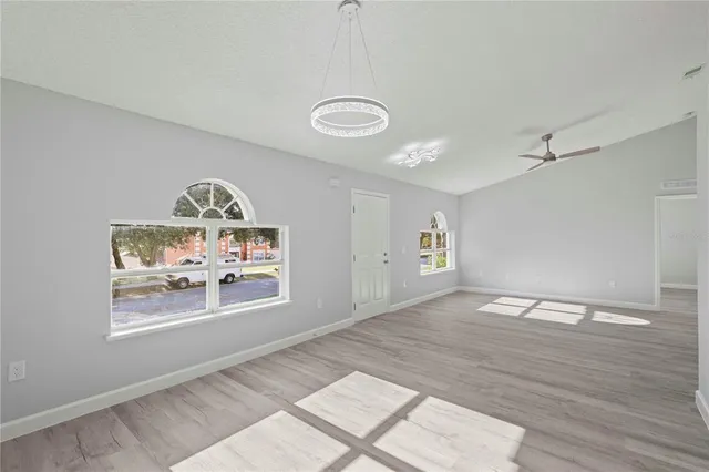 a view of a room with wooden floor and window