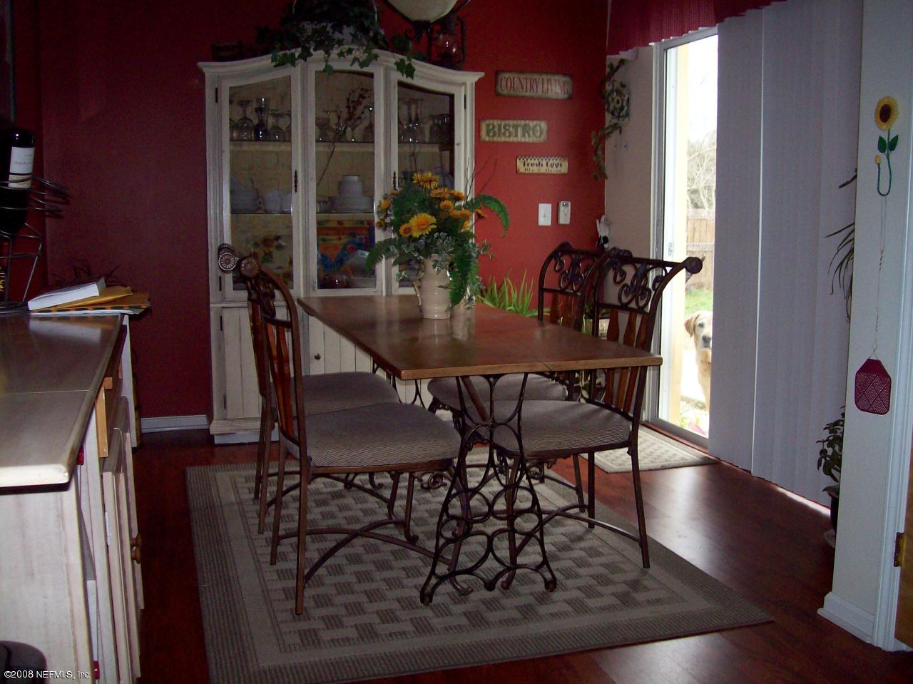 44238 Quail Ridge Avenue East Callahan, FL 32011 - Photo 4 of 9 a view of a dining room with furniture and wooden floor