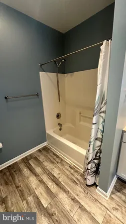 a bathroom with a bathtub and shower