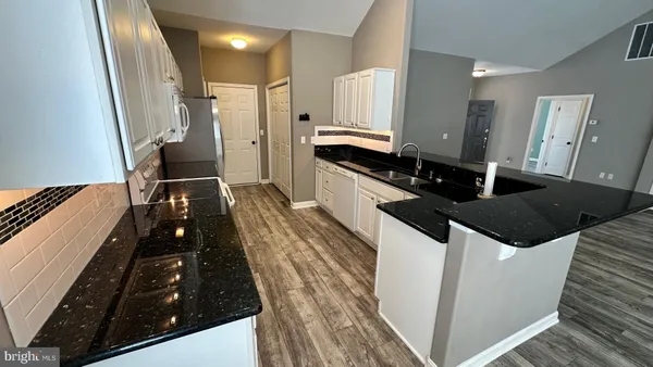 a kitchen with a sink and wooden cabinets