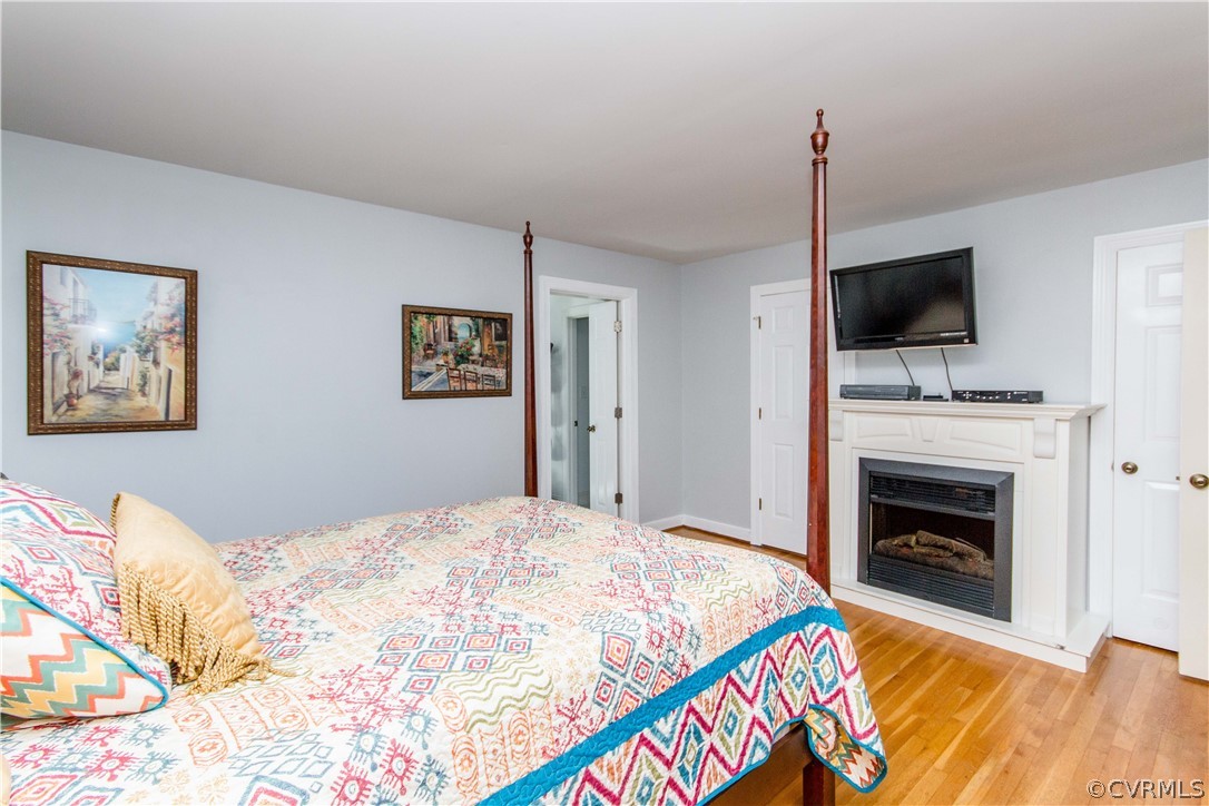 4017 Hidden Valley Road Chester, VA 23831 - Photo 20 of 50 a bedroom with a fireplace and a flat screen tv