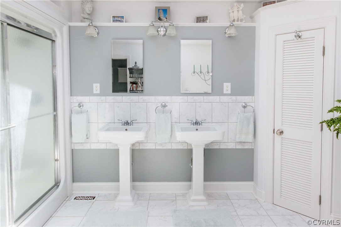 4017 Hidden Valley Road Chester, VA 23831 - Photo 29 of 50 a bathroom with a sink a bathtub and a mirror