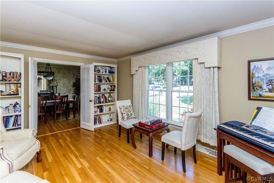 4017 Hidden Valley Road Chester, VA 23831 - Photo 5 of 50 a living room with furniture a dining table and a bookshelf with wooden floor