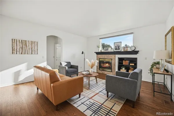 a living room with furniture and a fireplace