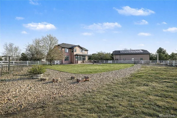 a view of yard with swimming pool and green space
