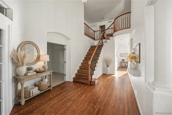 a view of entryway and hall with wooden floor