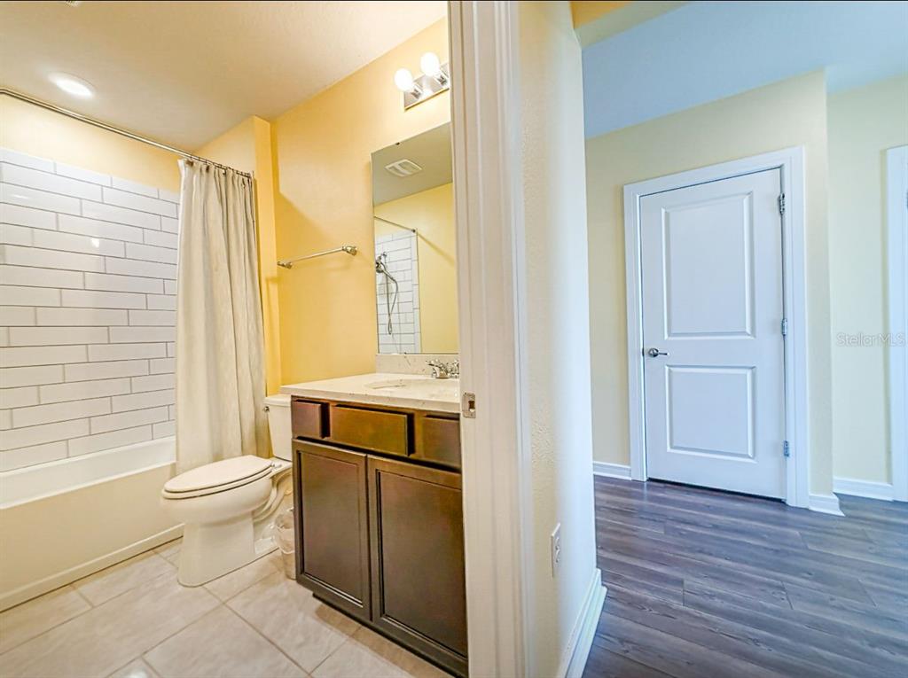 9324 Rally Spring Loop Wesley Chapel, FL 33545 - Photo 12 of 57 a bathroom with a sink toilet and shower