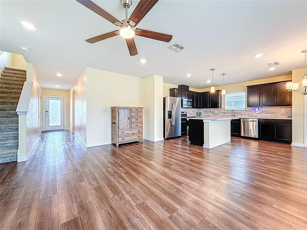 9324 Rally Spring Loop Wesley Chapel, FL 33545 - Photo 14 of 57 a view of kitchen with microwave a stove and wooden floor