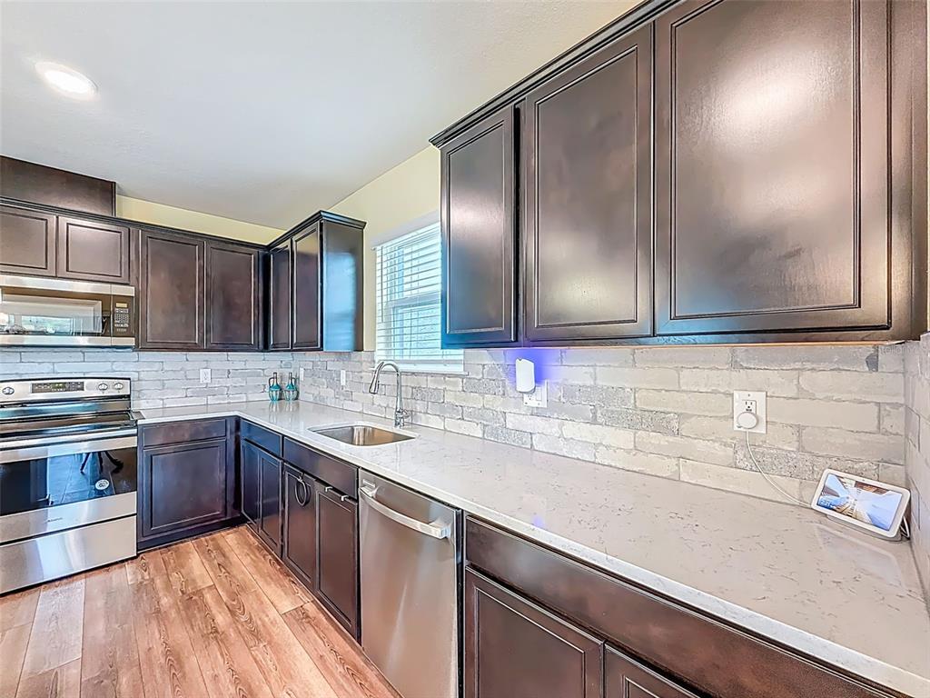 9324 Rally Spring Loop Wesley Chapel, FL 33545 - Photo 16 of 57 a kitchen with a sink and cabinets